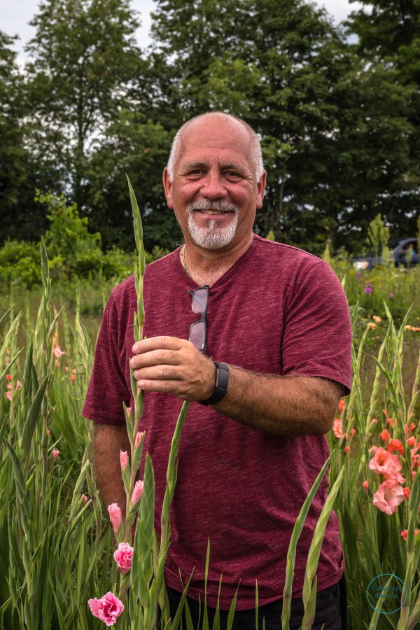 Gus Primeau holds a flower grown at his farm The Back 40 in Pontypool, Ontario.