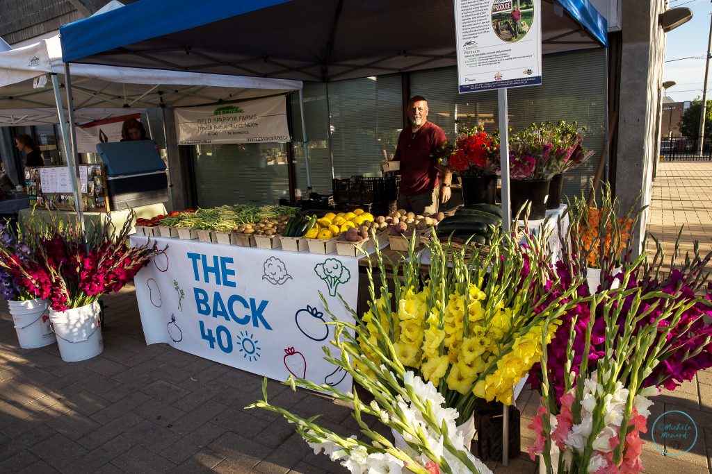 Gus Primeau, owner The Back 40 farm, stands behind his display at the Peterborough Regional Farmers' Market.